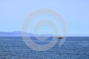 Excursion boat cruising Venetian harbour and mediterranean sea of Chania, Crete, Greece