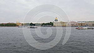 Excursion ships are floating on Neva river, background of view on Saint Petersburg