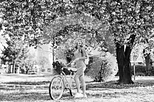 Excursion to garden. Athletic woman ride retro bicycle. Travel by bike. Weekend concept. Spring holidays. Riding bicycle