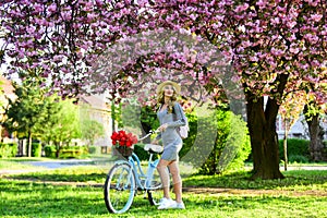 Excursion to garden. Athletic woman ride retro bicycle. Travel by bike. Weekend concept. Spring holidays. Riding bicycle