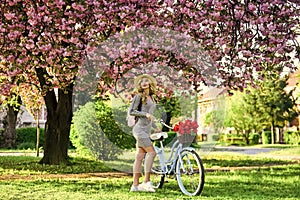 Excursion to garden. Athletic woman ride retro bicycle. Travel by bike. Weekend concept. Spring holidays. Riding bicycle