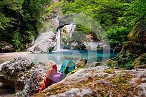 Excursion to the waterfall. Three backpacks between rocks