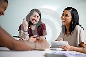 Executing their plans right down to the detail. a group of businesspeople having a discussion in an office.