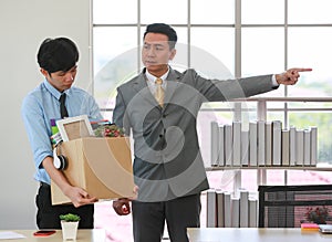 Executive boss Asian businessman in suit standing with anger and pointing finger action as give get fired for young employee who