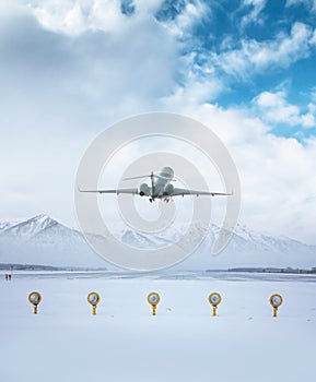 Executive business jet take off from airport runway against the backdrop of picturesque snow-capped mountains