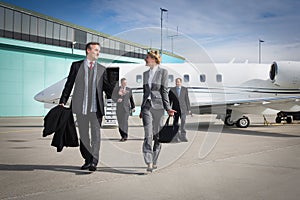 Executive business team leaving corporate jet