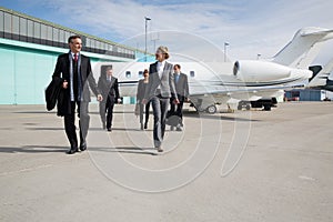 Executive business team leaving corporate jet