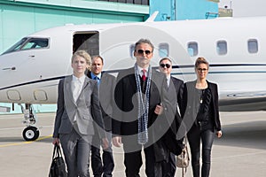 Executive business team leaving corporate jet