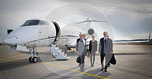 Executive business team leaving corporate jet