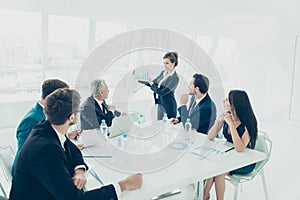 Executive business woman presenting her idea to colleagues at meeting photo