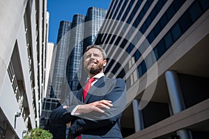 Executive businessman. Portrait of ceo near modern office in suit. Happy leader standing in front of company building.