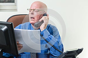 Executive comparing computer and written notes
