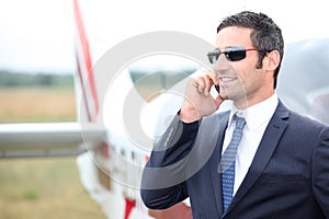 Executive in front of plane