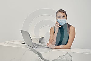 Executive girl making call wearing face mask