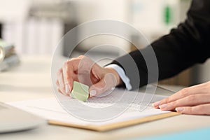 Executive hands erasing with rubber sits at office