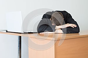 Executive Man Leaning on Desk with laptop photo