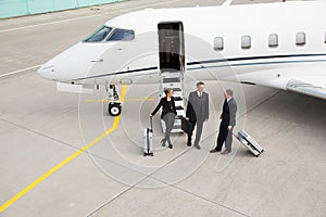 Executive manager in front of corporate jet