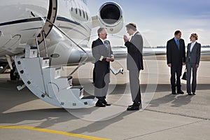 Executive manager instructung pilot of corporate jet