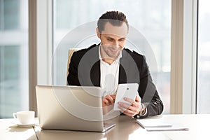 Executive manager using mobile app for banking