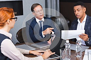 Executive pointing with finger at paper