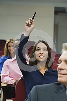 Executive Raises Hand During A Seminar