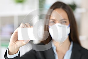 Executive showing blank credit card avoiding covid-19 at office