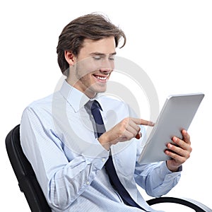 Executive sitting on a chair browsing a tablet