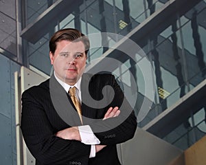 Executive standing in front of an office building