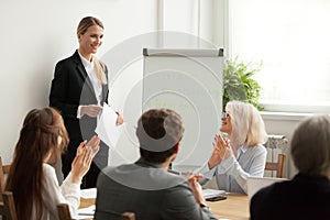 Executive team congratulating successful female manager with app