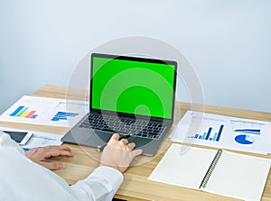 executive use touchpad on laptop, green screen for making presentation