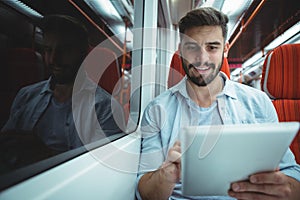 Executive using digital tablet travelling in train