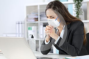 Executive wearing mask praying at the office