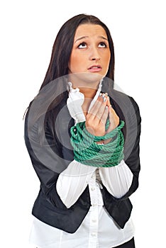 Executive woman with tied hands praying