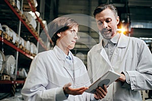 Executive and a worker having discussion at the factory warehouse