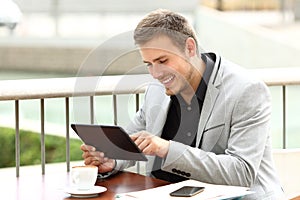 Executive works with a tablet in a coffee shop photo