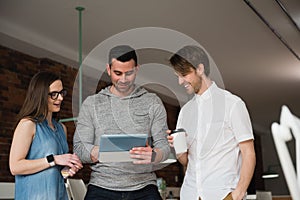 Executives discussing over digital tablet in office