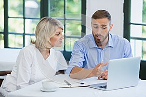 Executives discussing over laptop