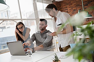 Executives discussing over laptop