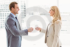 Executives exchanging business card in office