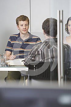 Executives Sitting At Conference Table