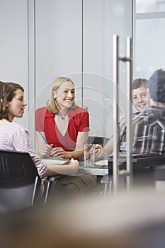 Executives Sitting At Conference Table