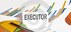 EXECUTOR text on paper on chart background with pen photo