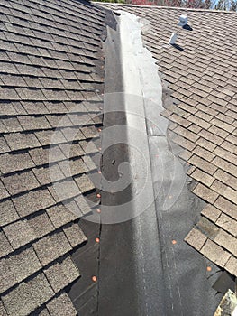 Exemplary Roof leak repairs on valley of residential shingle roof; roofing
