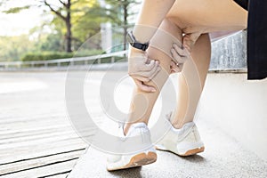 Exercise Associated Muscle Cramps,woman suffering from calf pain,muscular spasms and cramps or Achilles tendinitis,damage to photo