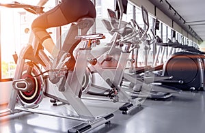 Exercise bike cardio workout at fitness gym photo