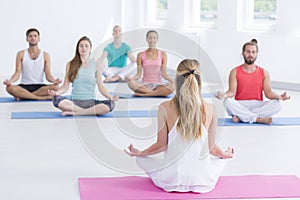 Exercise class practicing yoga indoors