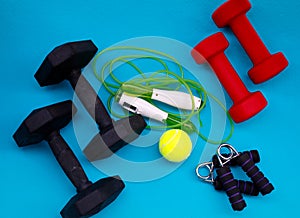 Exercise equipment. Weights, jump rope, tennis ball, hand grip strengthener.