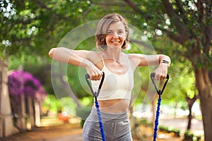 Exercise with fitness rubber bands outdoor. Fitness and healthcare concept