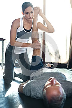 With exercise, the golden years just keep getting better. a senior man working out with his physiotherapist.