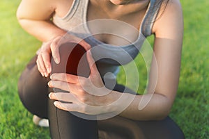 Exercise and healthy concept, Young woman asian have accident knee twist sprain in sport exercise jogging, Selective focus